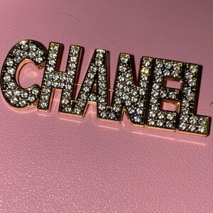 CHANEL Stamped Gold Crystal Logo Brooch